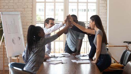 Colleagues high-fiving each other
