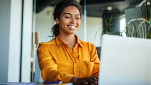 Woman on laptop, smiling