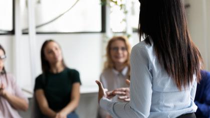 Woman presenting to colleagues