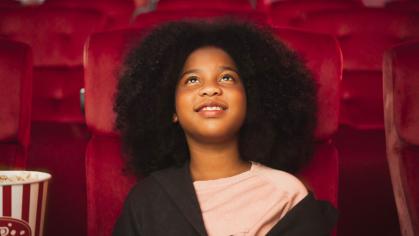 Girl watching a movie in a theater