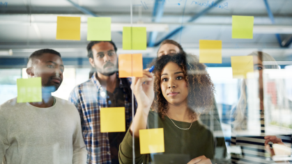 Colleagues hanging up post-it notes