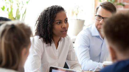 Woman speaking to colleagues