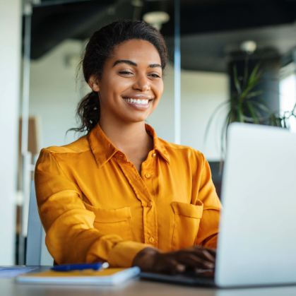 Woman on laptop, smiling