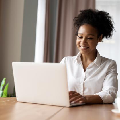 Woman smiling while on her laptop