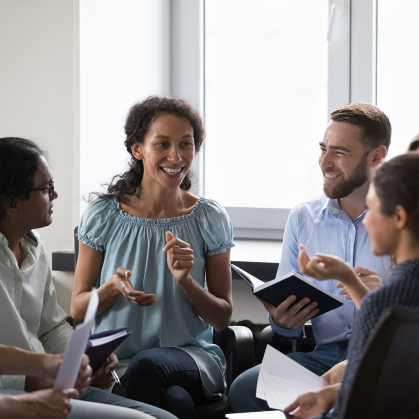 Colleagues sitting in a circle, speaking with one another