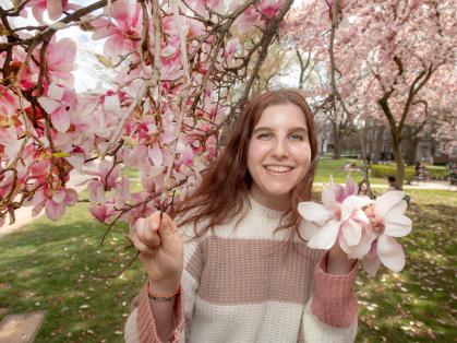 Talia Rosen posed in front of cherry blossom tree